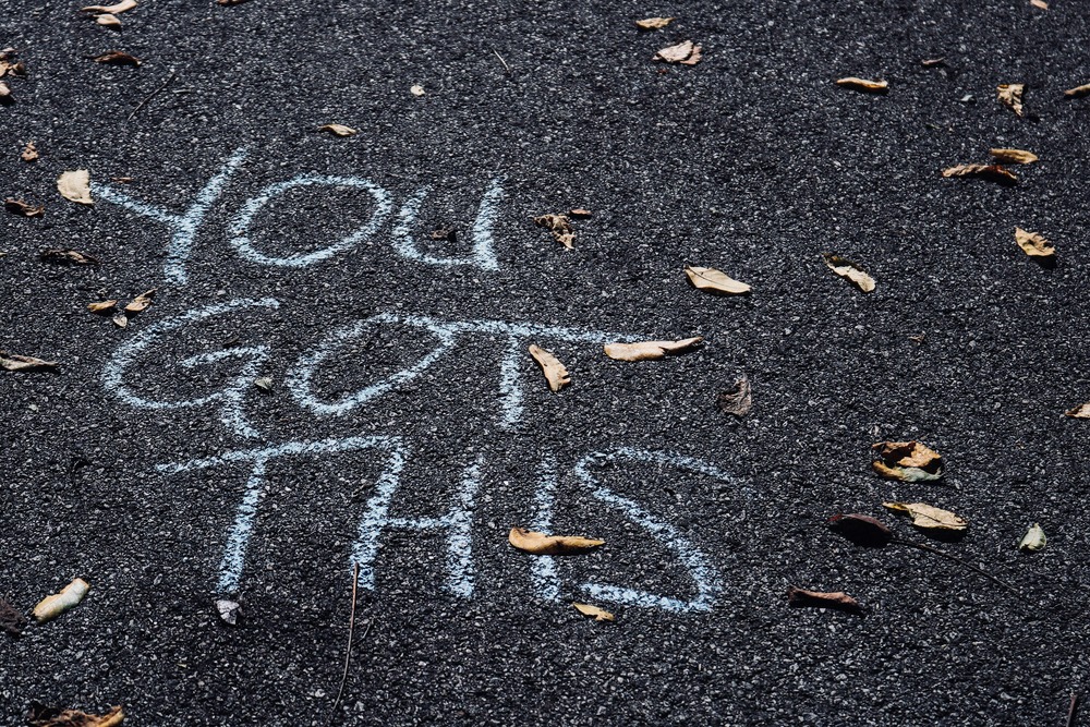 "You got this" message written on a tarmac road