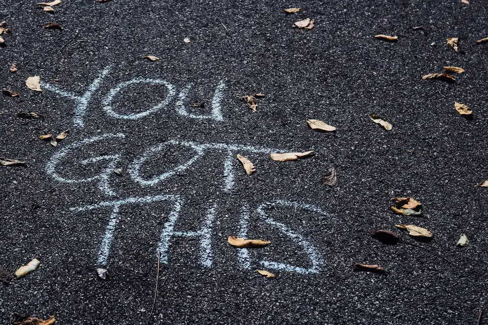 "You got this" message written on a tarmac road