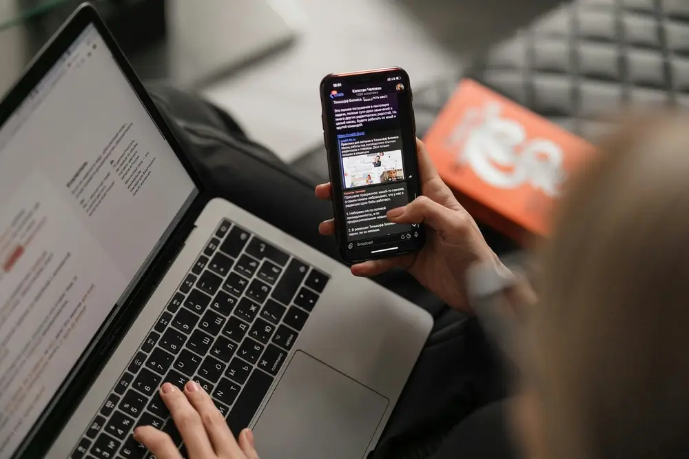 someone working on a computer and smartphone